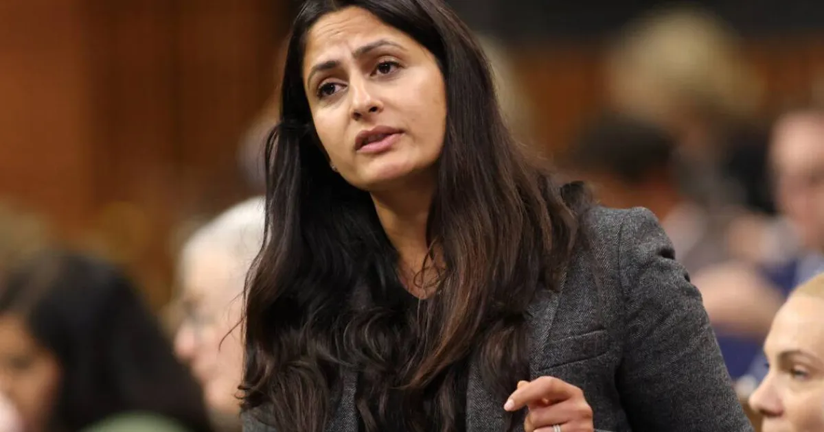 A woman with black hair speaking to a crowd.